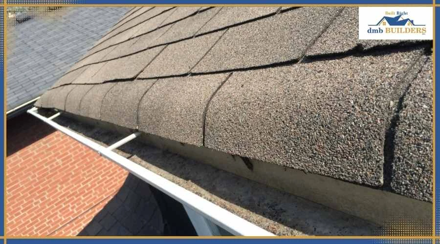 Granules inside gutter indicating shingle wear and bald spots forming on roof