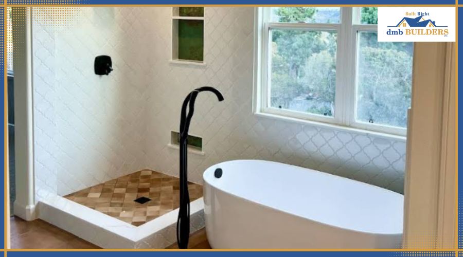 A modern bathroom featuring a white freestanding soaking tub and a walk-in shower with patterned floor tiles.